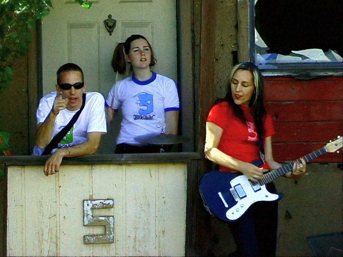 A group of Groovie Ghoulies standing in front of a house for their Monster Club meeting.