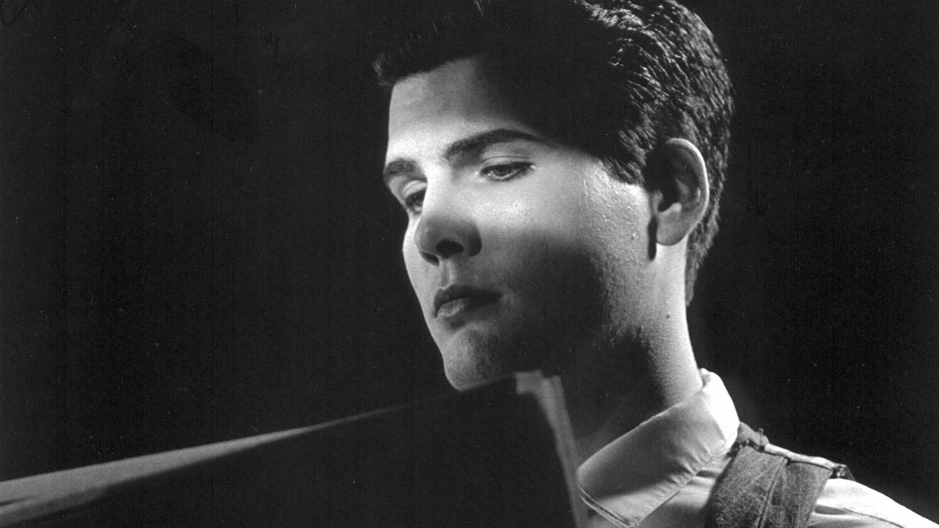 Black and White photo of Joe Gillis reading a tabloid newspaper